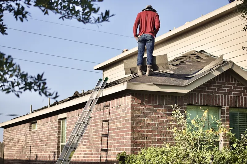 Professional roofer working on a residential roof in Bellvue